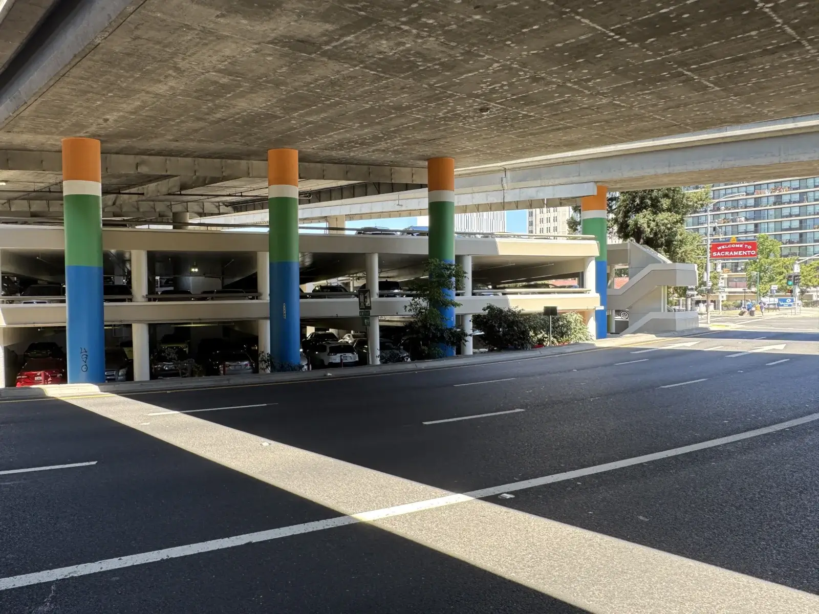 Old Sacramento, 4 level concrete parking garage structure with pillars under elevated highway 5 on J Street. After Blackhawk Painting Inc. commercial painting.