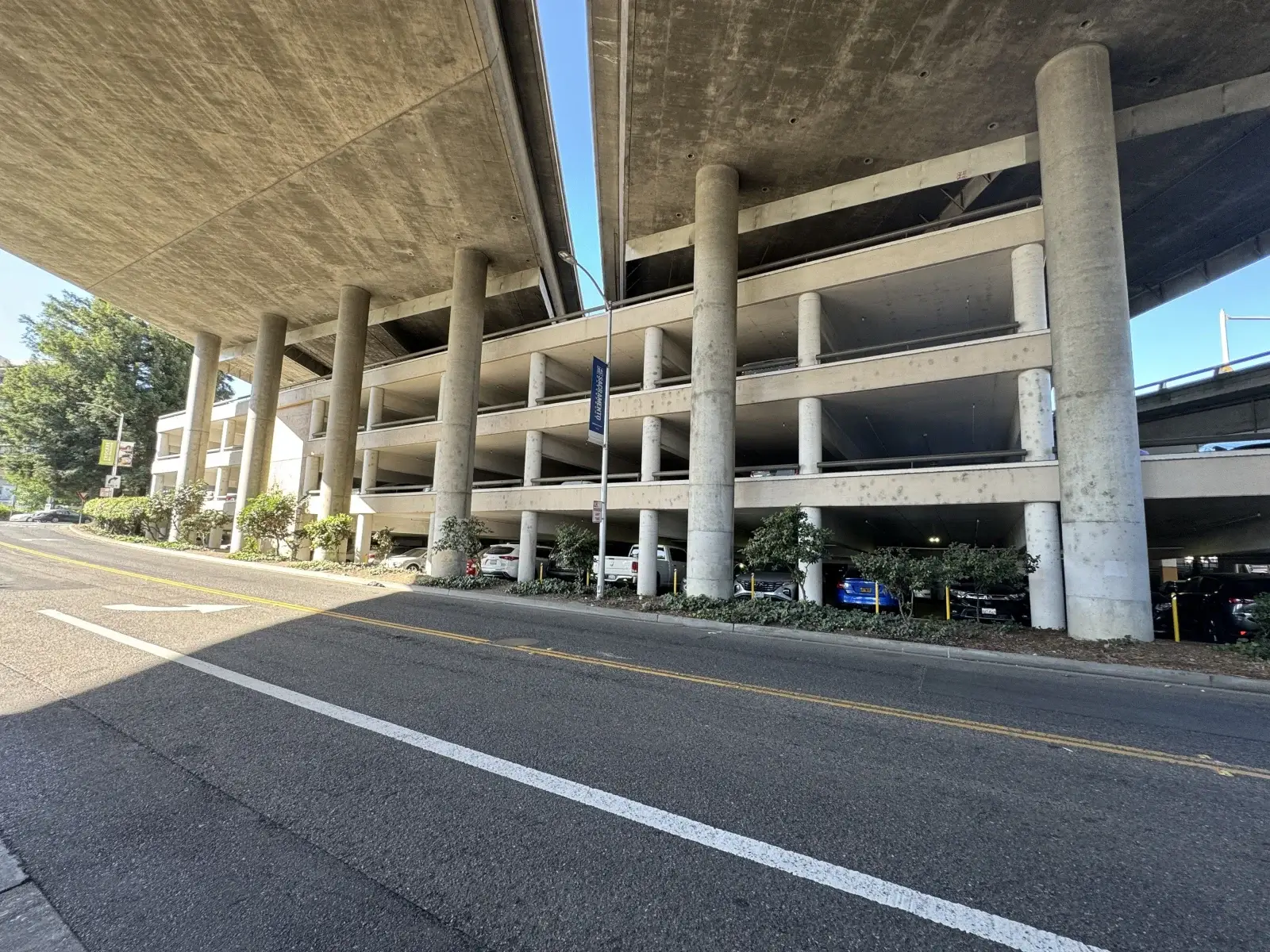 Before Old Sacramento, 4 level concrete parking garage structure with colorful pillars under elevated highway 5 on J Street was painted by Blackhawk Painting, Inc.