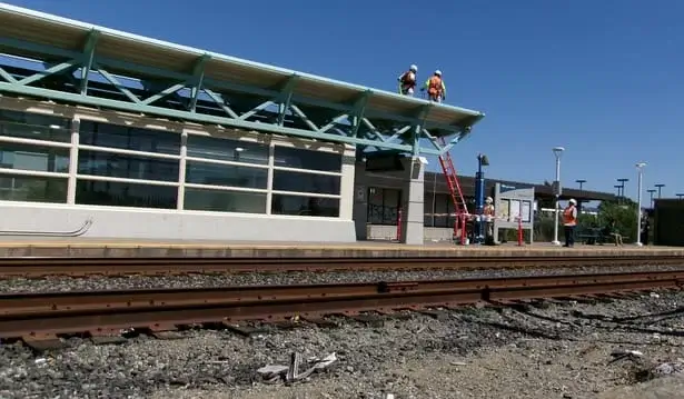 Blackhawk Painting, Inc. painting team working on surface preparation before painting Richmond Amtrak Station platform in Richmond, CA.